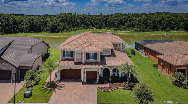 29038 Picana Ln, Wesley Chapel, FL 33543 - view of front of home with a tile roof, decorative driveway, stucco siding, and a water view