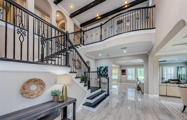 29038 Picana Ln, Wesley Chapel, FL 33543 - foyer entrance featuring arched walkways, a high ceiling, ornamental molding, stairway, and recessed lighting