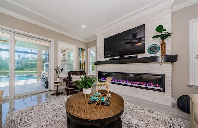 29038 Picana Ln, Wesley Chapel, FL 33543 - living area with a glass covered fireplace, crown molding, and recessed lighting