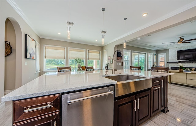29038 Picana Ln, Wesley Chapel, FL 33543 - kitchen with stainless steel dishwasher, open floor plan, hanging light fixtures, light stone countertops, and ceiling fan