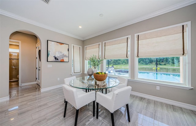 29038 Picana Ln, Wesley Chapel, FL 33543 - dining space featuring arched walkways, ornamental molding, and recessed lighting