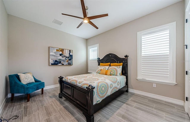 29038 Picana Ln, Wesley Chapel, FL 33543 - bedroom with wood tiled floors and ceiling fan
