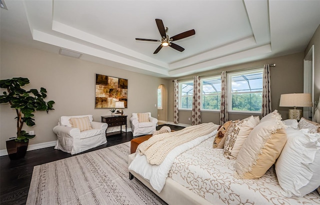 29038 Picana Ln, Wesley Chapel, FL 33543 - bedroom featuring a raised ceiling, wood finished floors, and a ceiling fan