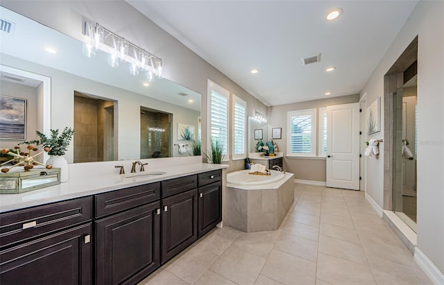29038 Picana Ln, Wesley Chapel, FL 33543 - bathroom with a stall shower, a bath, vanity, tile patterned flooring, and recessed lighting