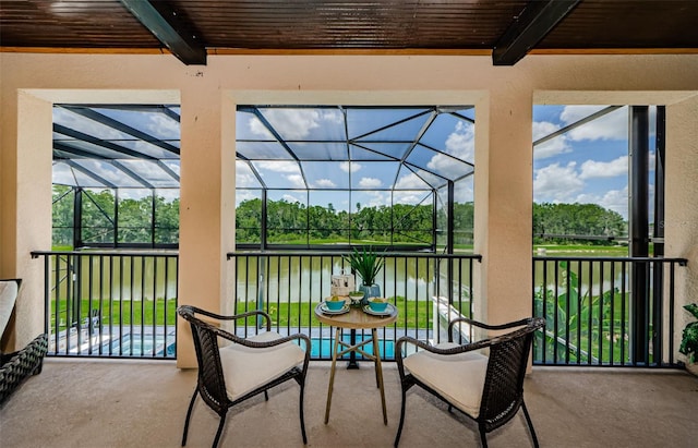29038 Picana Ln, Wesley Chapel, FL 33543 - view of patio with a water view, view of scattered trees, and glass enclosure