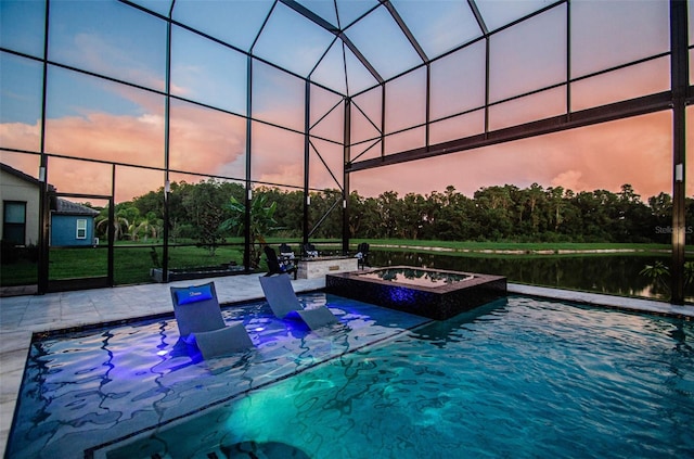 29038 Picana Ln, Wesley Chapel, FL 33543 - pool at dusk with a patio and a pool with connected hot tub