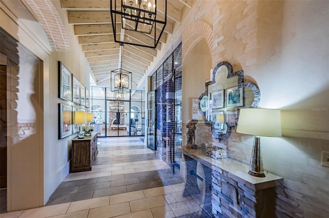 29038 Picana Ln, Wesley Chapel, FL 33543 - hallway featuring a chandelier, a towering ceiling, and tile patterned floors