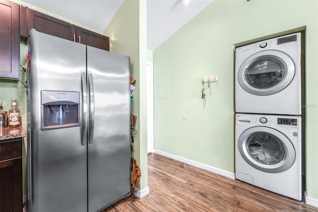 3002 W Cleveland St Unit B9, Tampa, FL 33609 - laundry room featuring stacked washer / drying machine and light wood-style floors