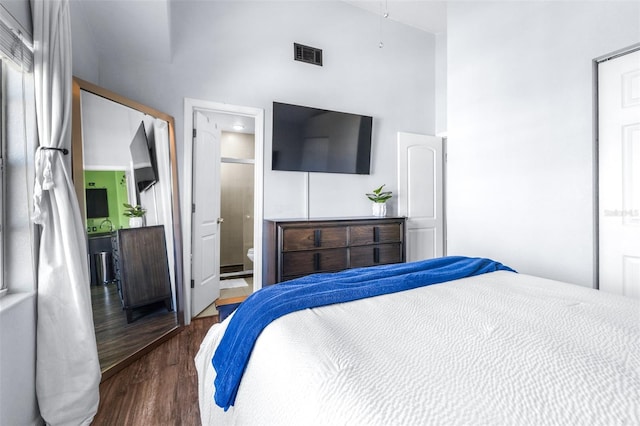 3002 W Cleveland St Unit B9, Tampa, FL 33609 - bedroom featuring a towering ceiling, wood finished floors, and ensuite bathroom