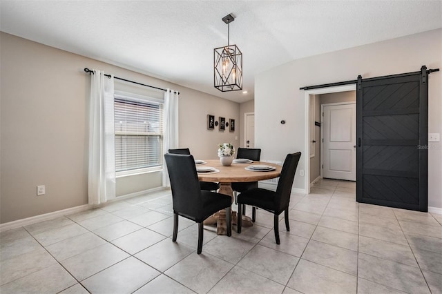 9839 Lemon Drop Loop, Sun City Center, FL 33573 - dining area featuring a barn door, light tile patterned floors, and a chandelier
