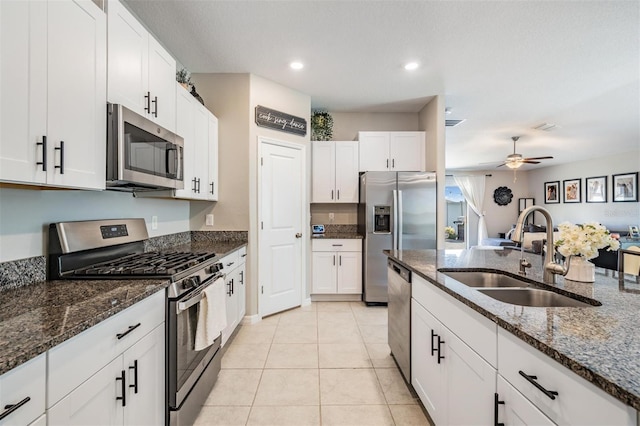 9839 Lemon Drop Loop, Sun City Center, FL 33573 - kitchen with stainless steel appliances, white cabinets, ceiling fan, dark stone countertops, and recessed lighting