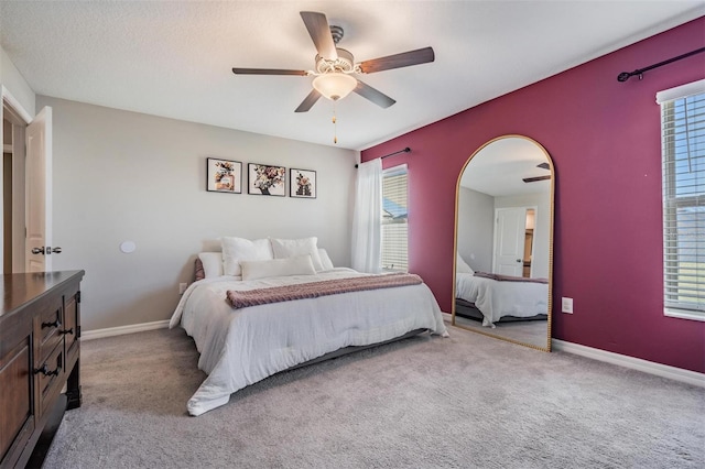 9839 Lemon Drop Loop, Sun City Center, FL 33573 - bedroom featuring multiple windows, carpet, and a ceiling fan