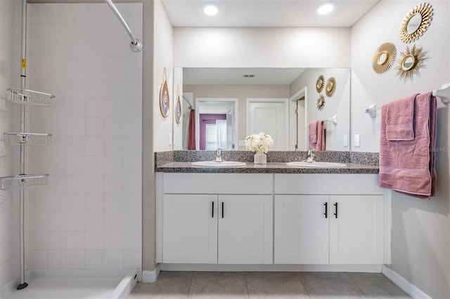 9839 Lemon Drop Loop, Sun City Center, FL 33573 - bathroom featuring double vanity, tiled shower, and tile patterned floors