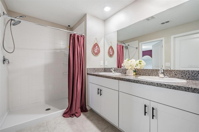 9839 Lemon Drop Loop, Sun City Center, FL 33573 - bathroom with tiled shower, double vanity, and tile patterned floors