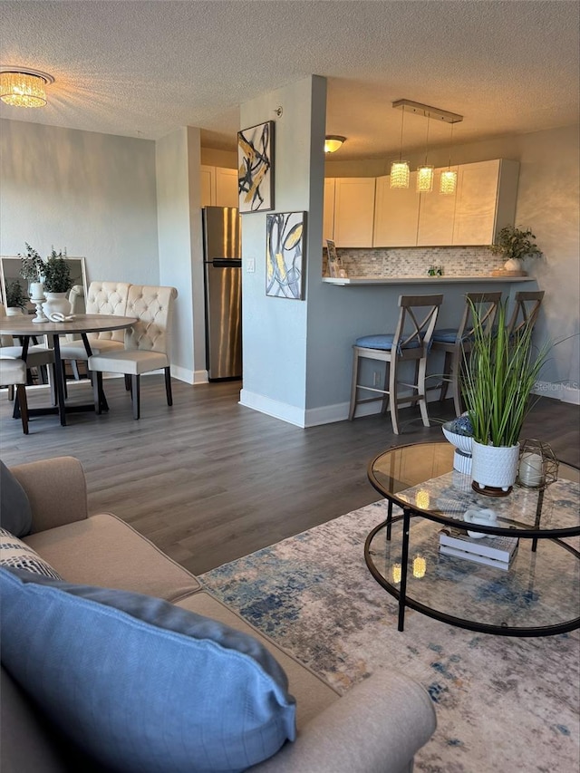 3315 58th Ave S Unit 421, Saint Petersburg, FL 33712 - living area featuring dark wood-type flooring and a textured ceiling