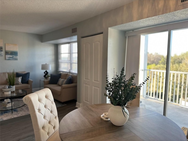 3315 58th Ave S Unit 421, Saint Petersburg, FL 33712 - dining room featuring dark wood-type flooring and a textured ceiling