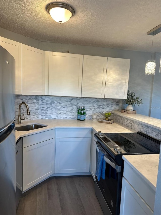 3315 58th Ave S Unit 421, Saint Petersburg, FL 33712 - kitchen with electric range, freestanding refrigerator, dark wood-style floors, light countertops, and a textured ceiling
