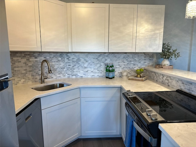 3315 58th Ave S Unit 421, Saint Petersburg, FL 33712 - kitchen featuring appliances with stainless steel finishes, light countertops, decorative backsplash, and white cabinetry