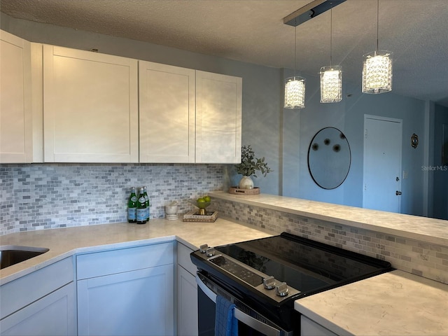 3315 58th Ave S Unit 421, Saint Petersburg, FL 33712 - kitchen featuring electric stove, light countertops, decorative backsplash, white cabinetry, and a textured ceiling