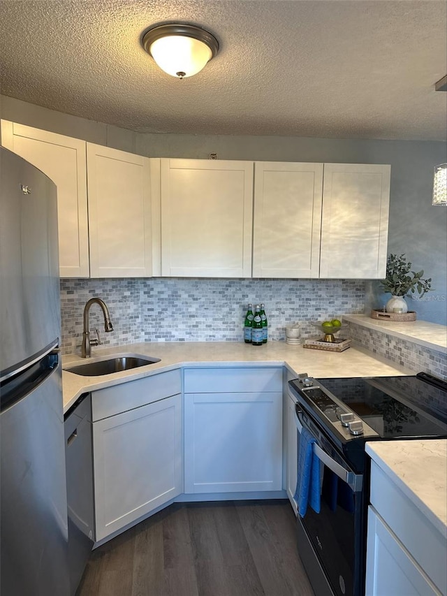 3315 58th Ave S Unit 421, Saint Petersburg, FL 33712 - kitchen featuring electric range oven, freestanding refrigerator, light countertops, dark wood-style flooring, and backsplash