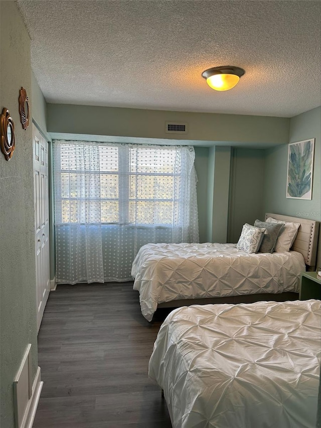 3315 58th Ave S Unit 421, Saint Petersburg, FL 33712 - bedroom featuring dark wood-style floors and a textured ceiling