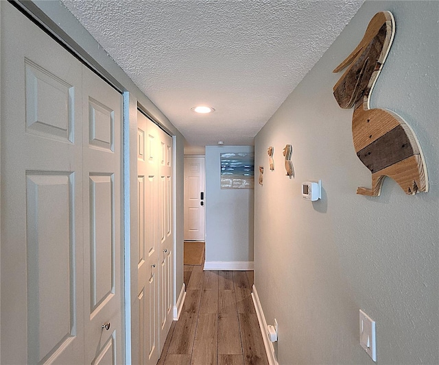 18650 Gulf Blvd Unit 314, Indian Shores, FL 33785 - hall featuring a textured ceiling and wood finished floors