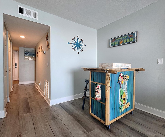 18650 Gulf Blvd Unit 314, Indian Shores, FL 33785 - hallway featuring wood finished floors and a textured ceiling