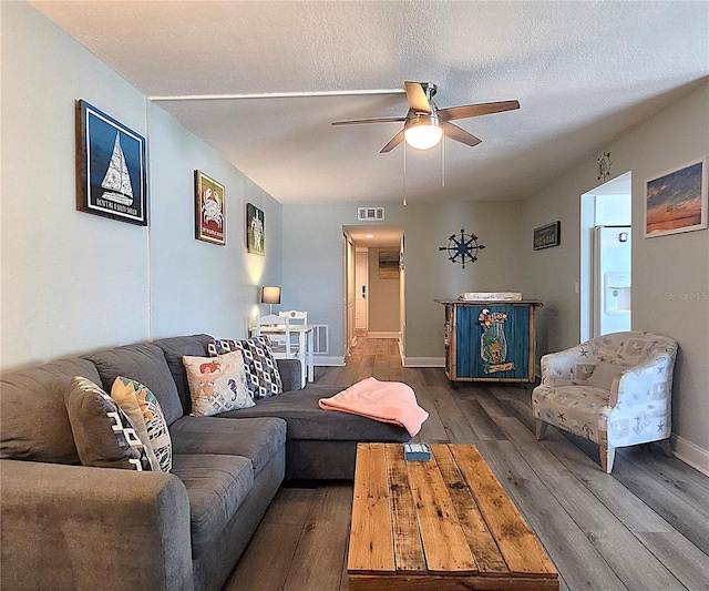 18650 Gulf Blvd Unit 314, Indian Shores, FL 33785 - living room featuring a ceiling fan, dark wood-style flooring, and a textured ceiling