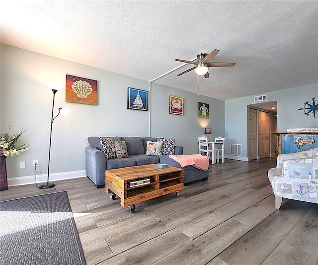 18650 Gulf Blvd Unit 314, Indian Shores, FL 33785 - living room featuring wood finished floors, ceiling fan, and a textured ceiling