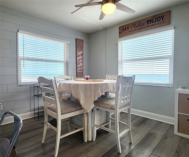 18650 Gulf Blvd Unit 314, Indian Shores, FL 33785 - dining room featuring ceiling fan, dark wood-style floors, and wood walls
