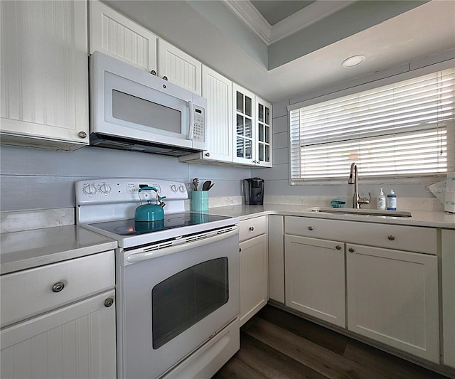 18650 Gulf Blvd Unit 314, Indian Shores, FL 33785 - kitchen featuring white appliances, ornamental molding, light countertops, dark wood-style floors, and white cabinets