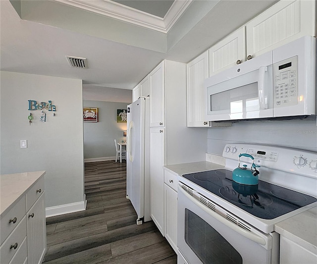 18650 Gulf Blvd Unit 314, Indian Shores, FL 33785 - kitchen with white appliances, ornamental molding, dark wood-type flooring, light countertops, and white cabinets