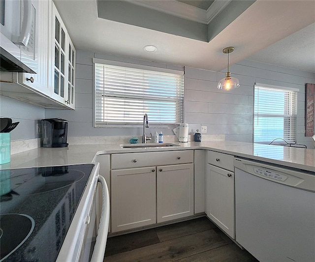18650 Gulf Blvd Unit 314, Indian Shores, FL 33785 - kitchen with white appliances, dark wood-style flooring, plenty of natural light, ornamental molding, and light countertops
