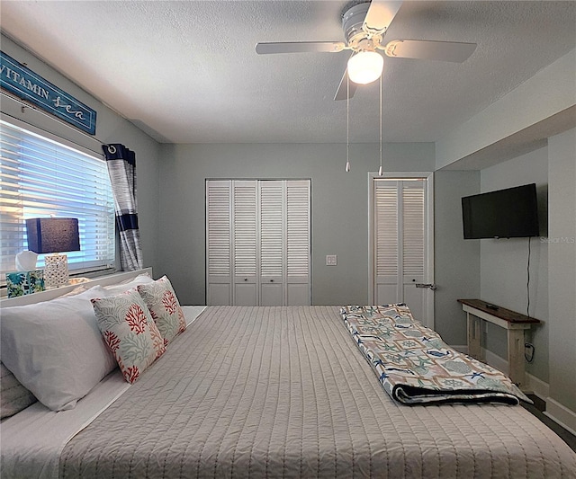18650 Gulf Blvd Unit 314, Indian Shores, FL 33785 - bedroom with two closets, a textured ceiling, and a ceiling fan