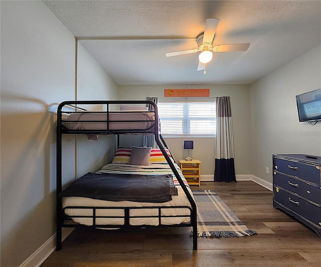 18650 Gulf Blvd Unit 314, Indian Shores, FL 33785 - bedroom with wood finished floors, a textured ceiling, and a ceiling fan
