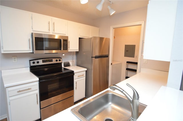 10265 Gandy Blvd N Unit 1409, Saint Petersburg, FL 33702 - kitchen featuring stainless steel appliances, light countertops, white cabinets, and rail lighting