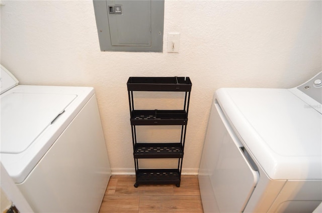 10265 Gandy Blvd N Unit 1409, Saint Petersburg, FL 33702 - laundry room with electric panel, washer and clothes dryer, and light wood-style flooring