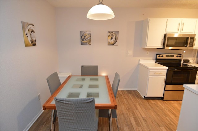 10265 Gandy Blvd N Unit 1409, Saint Petersburg, FL 33702 - dining area featuring baseboards and light wood-style flooring
