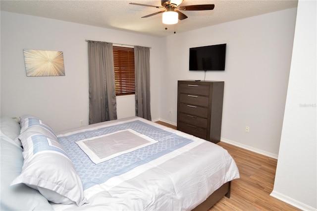10265 Gandy Blvd N Unit 1409, Saint Petersburg, FL 33702 - bedroom with light wood-type flooring, a textured ceiling, and ceiling fan