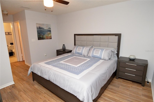 10265 Gandy Blvd N Unit 1409, Saint Petersburg, FL 33702 - bedroom with light wood-style flooring, a ceiling fan, and a textured ceiling