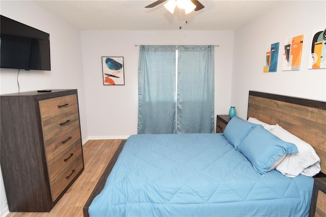 10265 Gandy Blvd N Unit 1409, Saint Petersburg, FL 33702 - bedroom with wood finished floors, a textured ceiling, and ceiling fan