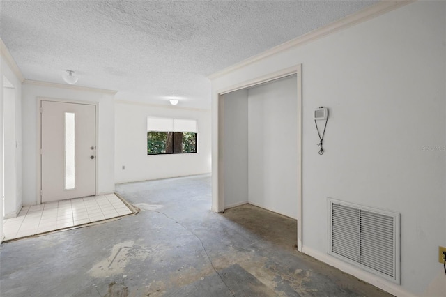 506 Duxbury Ct Unit A, Safety Harbor, FL 34695 - entrance foyer featuring unfinished concrete flooring, ornamental molding, and a textured ceiling
