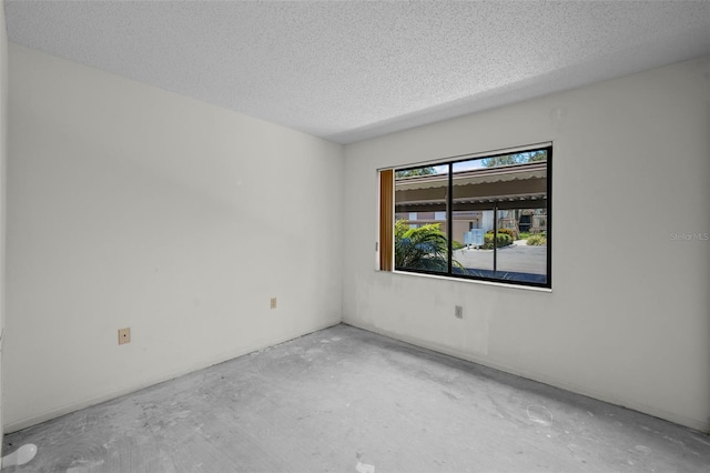 506 Duxbury Ct Unit A, Safety Harbor, FL 34695 - empty room with unfinished concrete floors and a textured ceiling