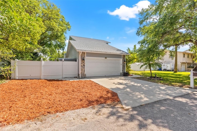 428 Klosterman Rd W, W, Palm Harbor, FL 34683 - view of front of home with an attached garage, driveway, and roof with shingles