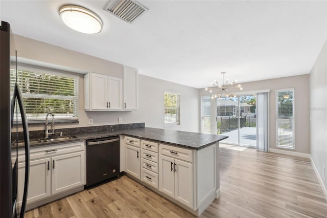 428 Klosterman Rd W, W, Palm Harbor, FL 34683 - kitchen with black dishwasher, a peninsula, plenty of natural light, and a chandelier
