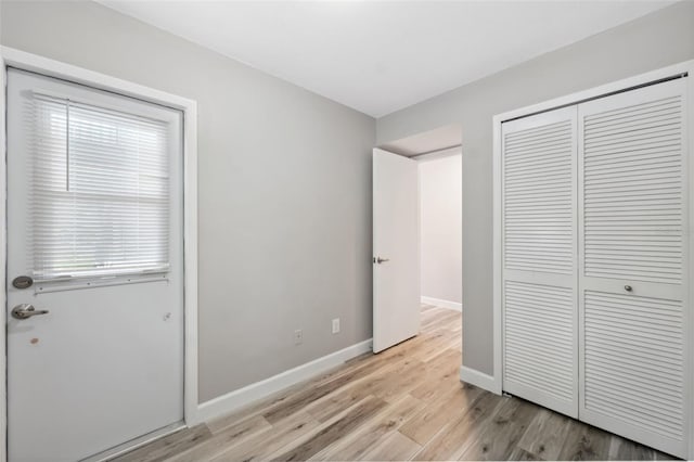 428 Klosterman Rd W, W, Palm Harbor, FL 34683 - unfurnished bedroom with light wood-style flooring and a closet