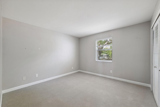 428 Klosterman Rd W, W, Palm Harbor, FL 34683 - unfurnished bedroom featuring carpet and a closet