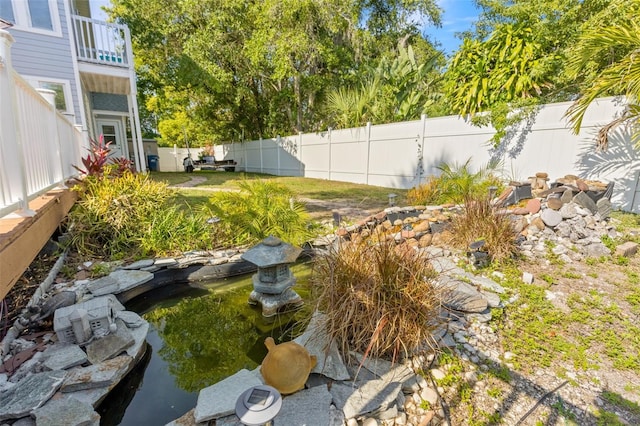 428 Klosterman Rd W, W, Palm Harbor, FL 34683 - fenced backyard with a small pond