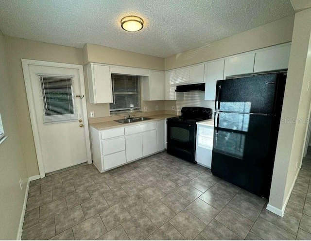 102,106,110,202,204 N Jasper Street 102,106,110,202,204, Bushnell, FL 33513 - kitchen featuring black appliances, under cabinet range hood, light countertops, white cabinetry, and a textured ceiling
