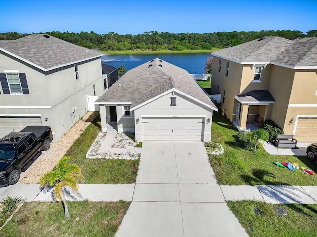 10024 Merry Fawn Ct, Sun City Center, FL 33573 - view of front of house featuring a garage, a water view, stucco siding, concrete driveway, and roof with shingles
